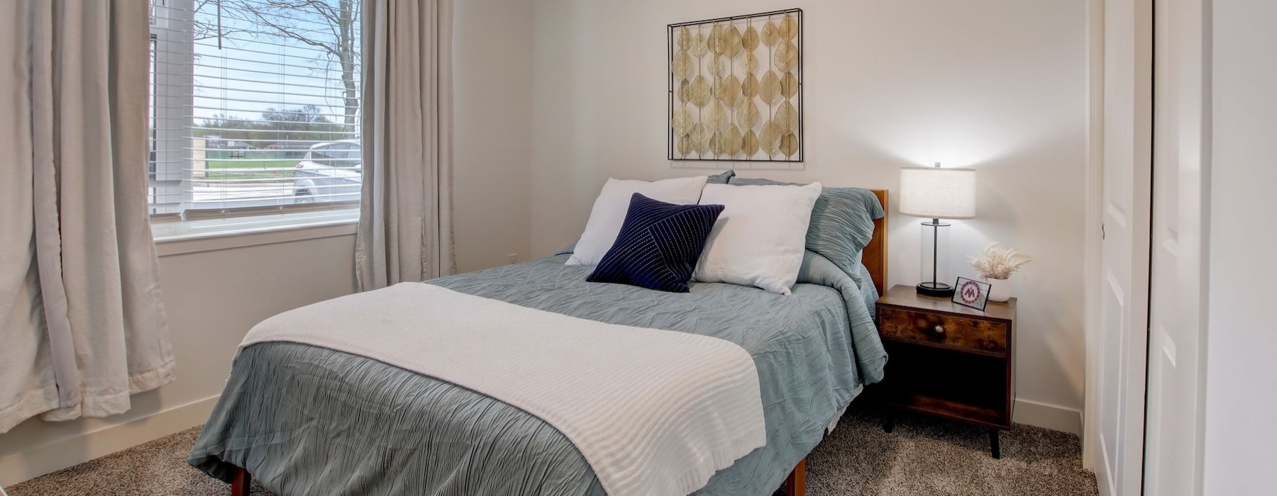 a bedroom with a bed and a window