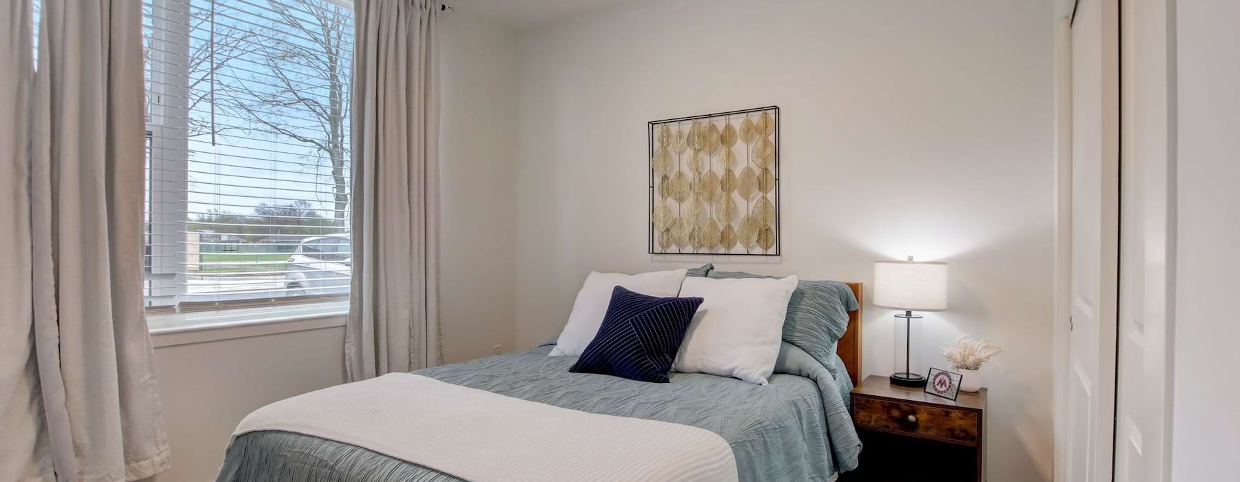 a bedroom with a bed and a window
