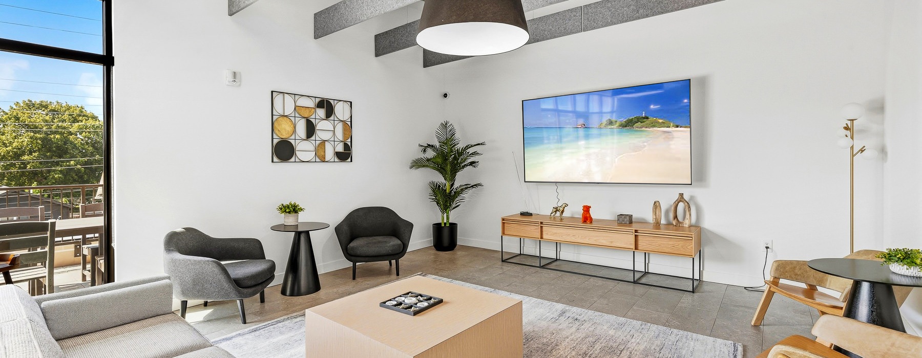 resident lounge with couch coffee table and wall mounted tv